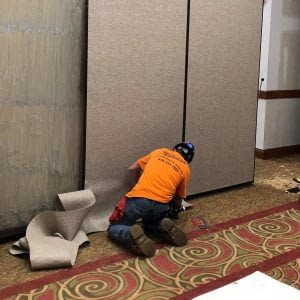 Image of technician repairing the operable walls